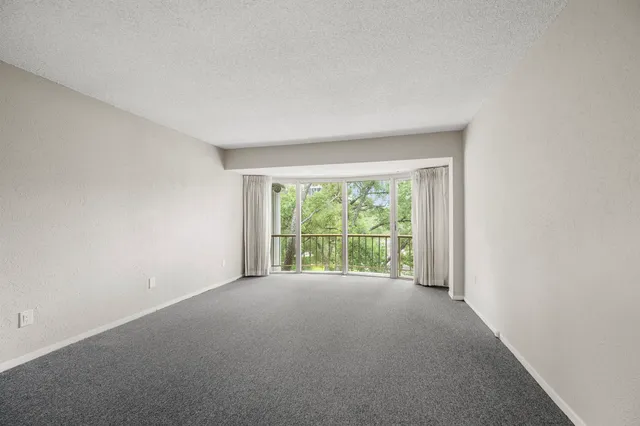a view of an empty room with a balcony
