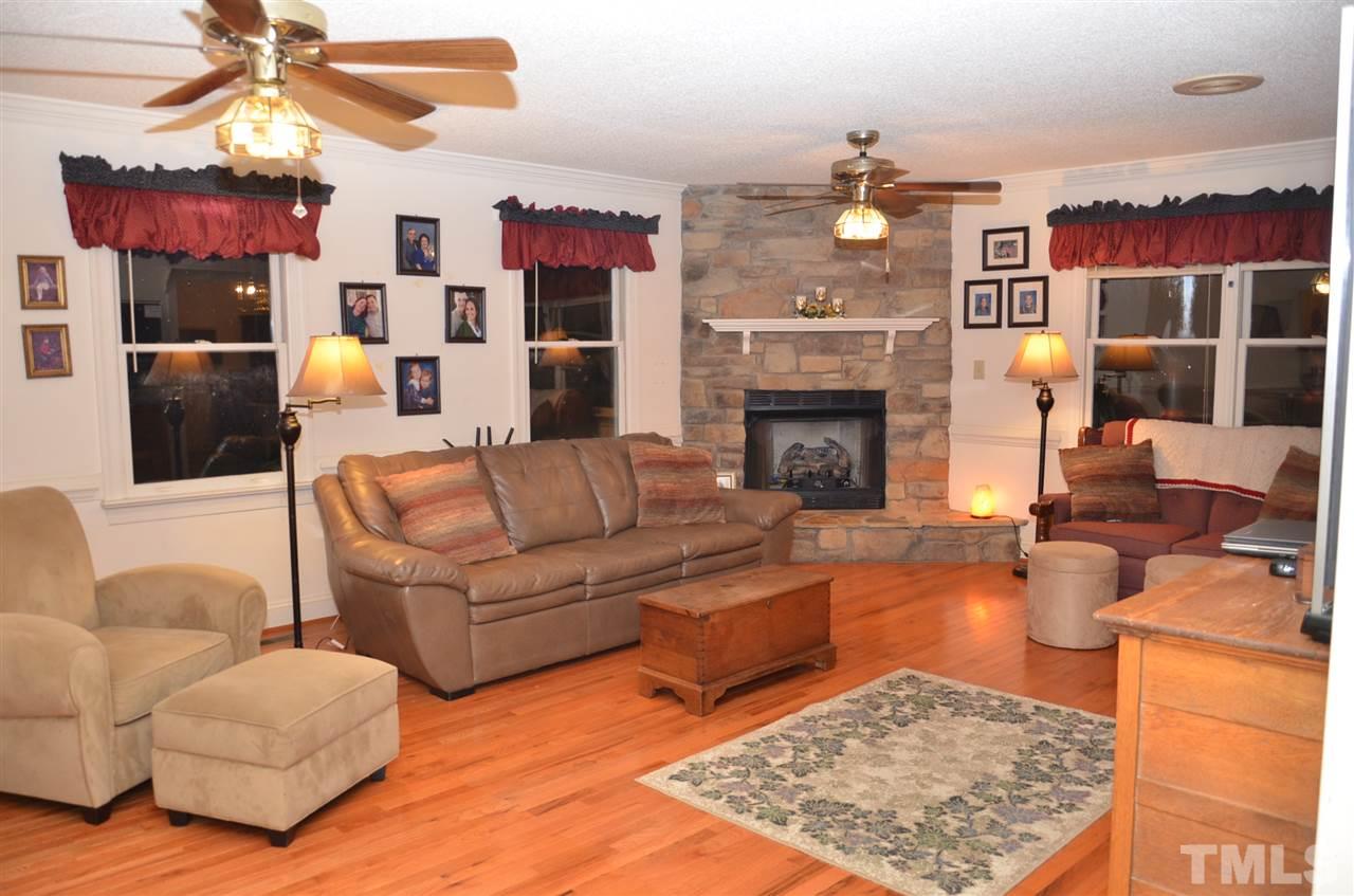 1000 Fate Washington Road Stem, NC 27581 - Photo 19 of 28 a living room with furniture kitchen view and a fireplace