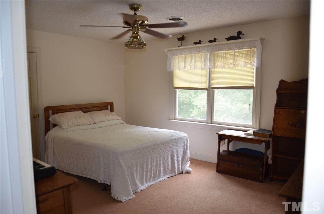 1000 Fate Washington Road Stem, NC 27581 - Photo 21 of 28 a bedroom with a bed and a window
