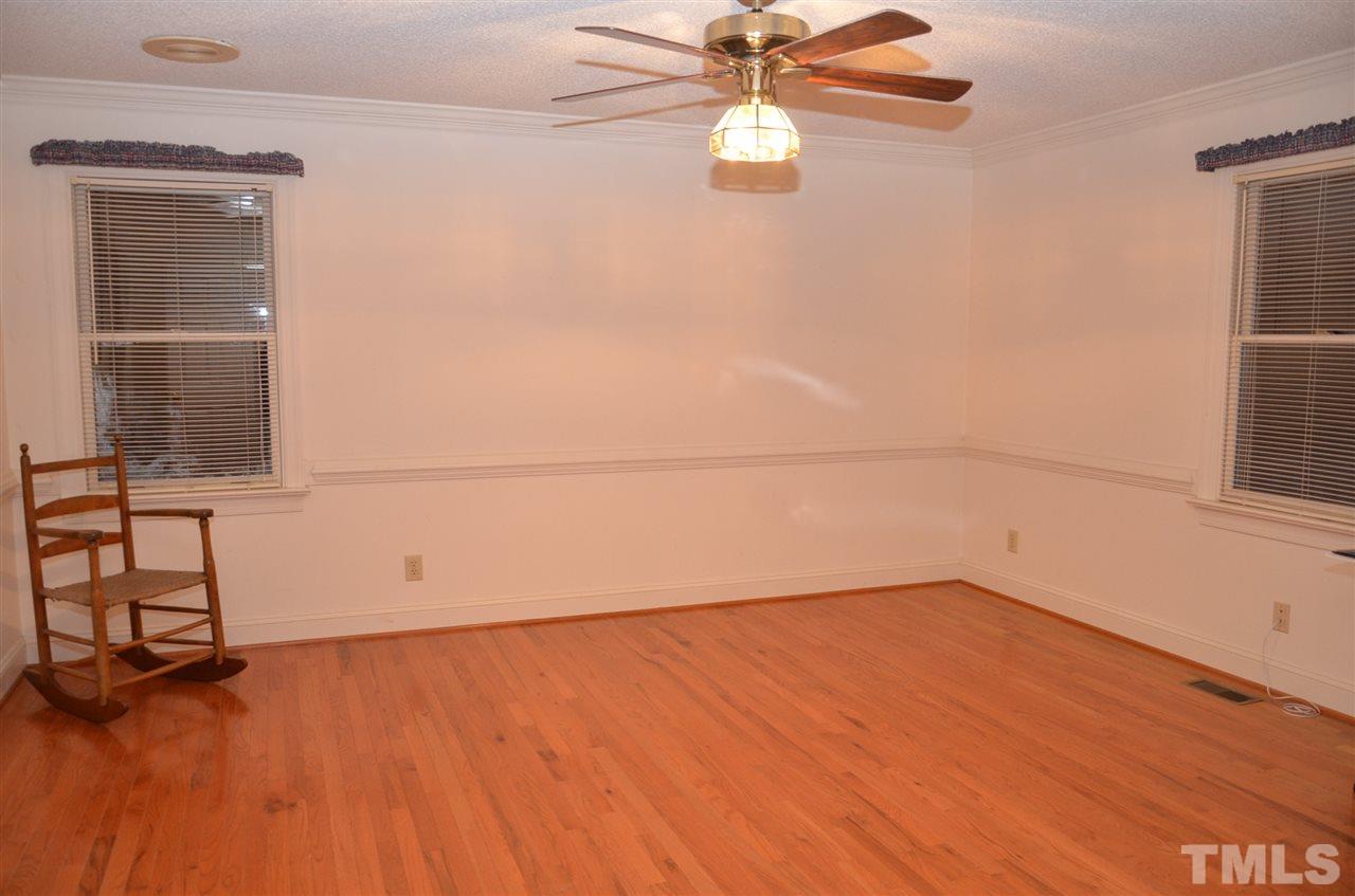 1000 Fate Washington Road Stem, NC 27581 - Photo 23 of 28 an empty room with wooden floor fan and windows