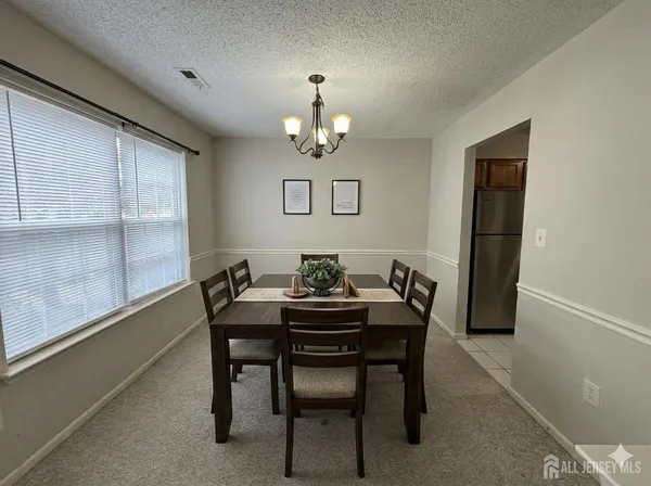 a dining room with furniture and window