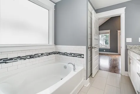 a bathroom with a bathtub and a shower