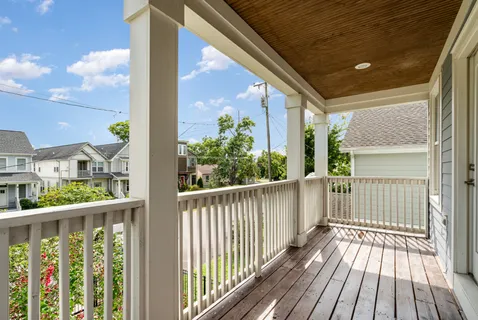a view of a balcony with wooden floor