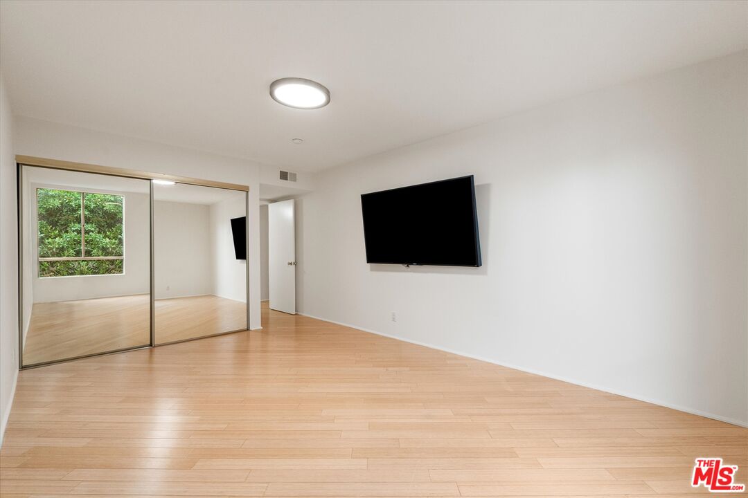 429 North Oakhurst Drive, Unit 203 Beverly Hills, CA 90210 - Photo 13 of 20 a view of empty room with wooden floor and fan
