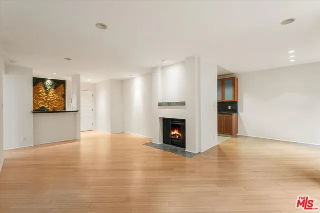 a view of an empty room with a fireplace