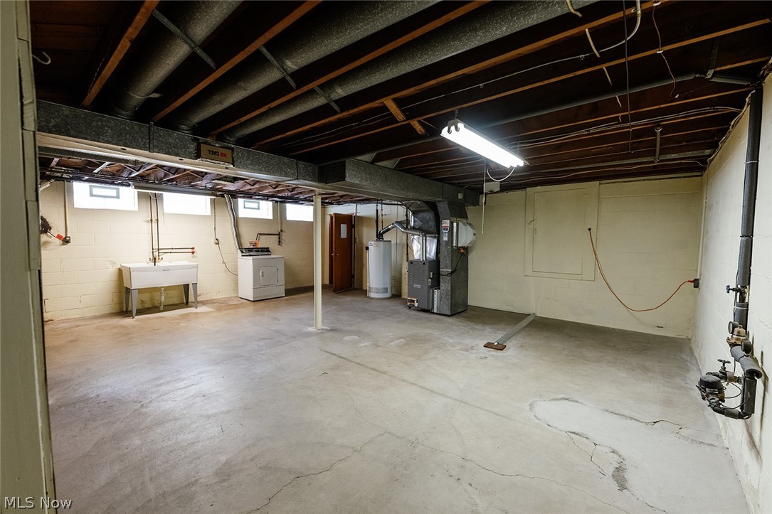 19545 Alexander Road Bedford, OH 44146 - Photo 24 of 29 Basement with water heater, heating utilities, sink, and washer / dryer