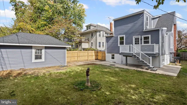 a view of a house with a small yard and wooden fence