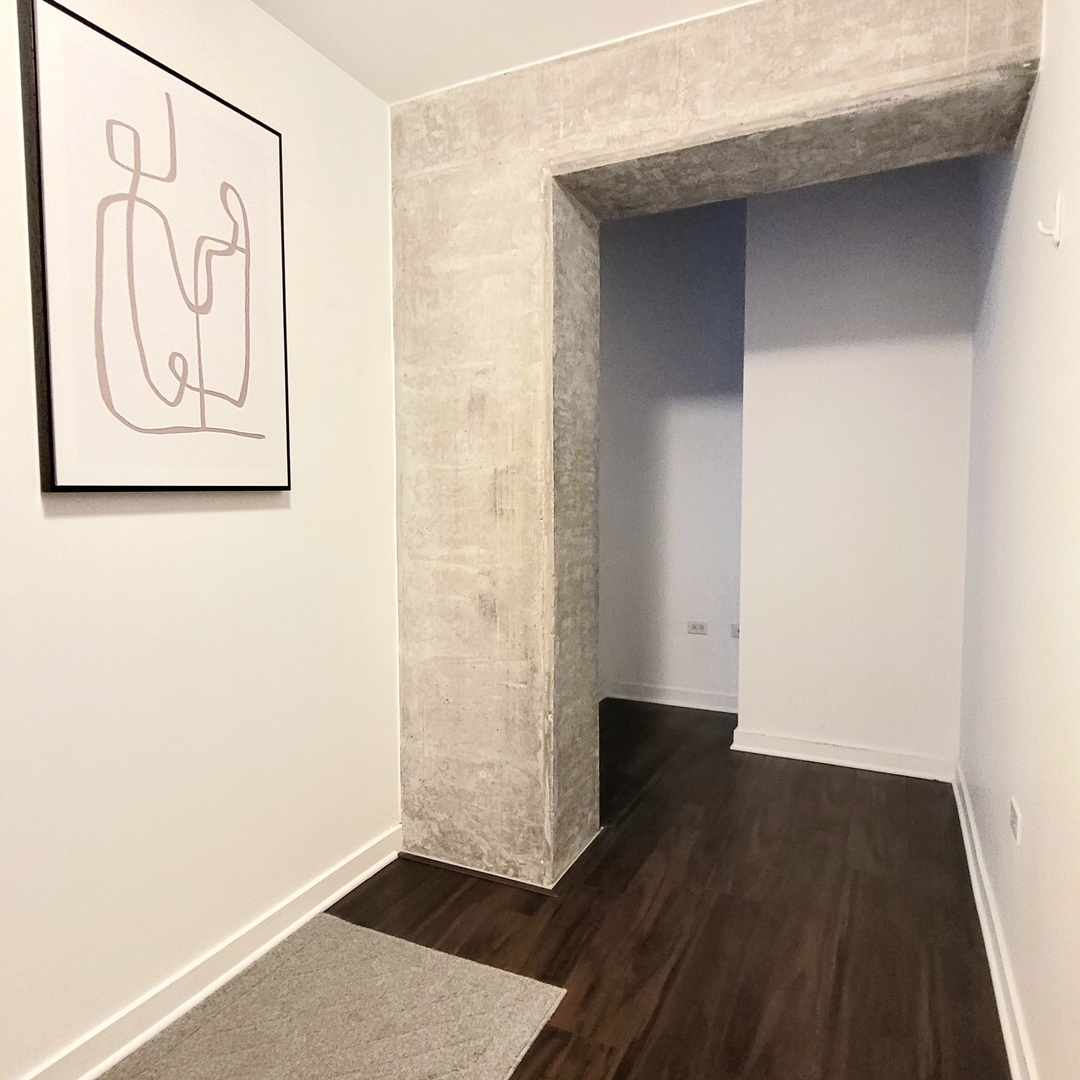 235 West Van Buren Street, Unit 4307 Chicago, IL 60607 - Photo 22 of 27 a view of an empty room with wooden floor