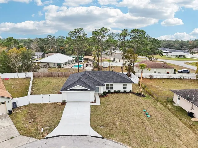 an aerial view of residential houses with city view