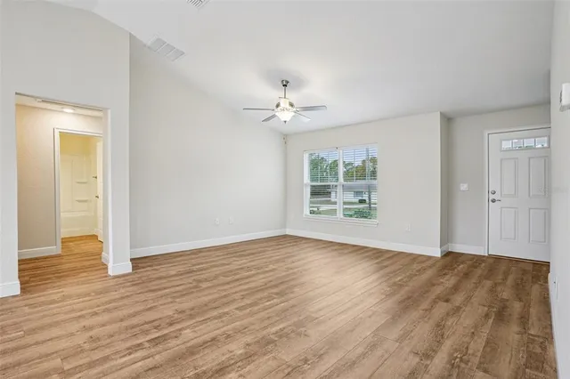 a kitchen with stainless steel appliances kitchen island hardwood floor sink and stove