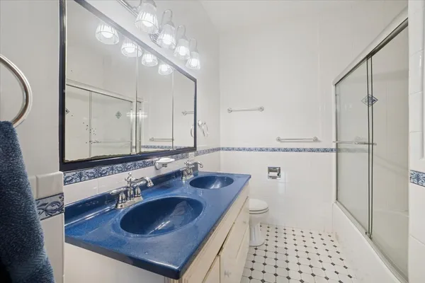 a bathroom with a sink toilet and shower