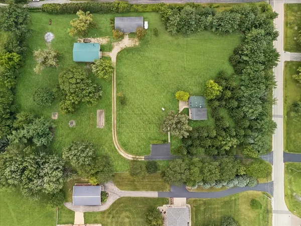 an aerial view of a houses with a yard