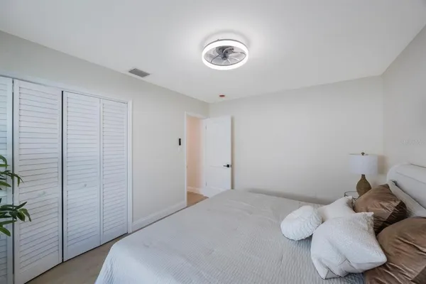 an empty room with wooden floor and mirror