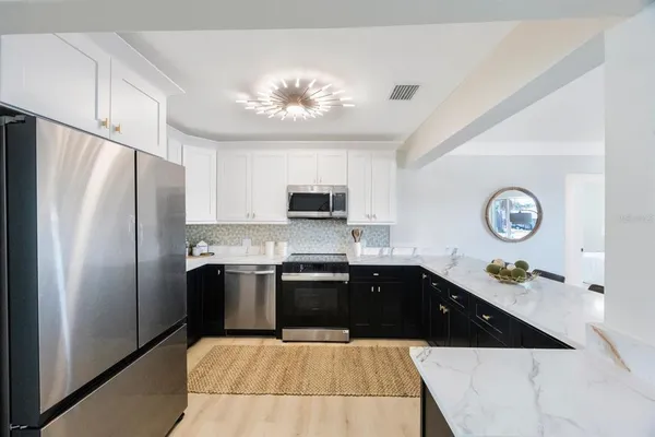 a kitchen with a sink stainless steel appliances and cabinets