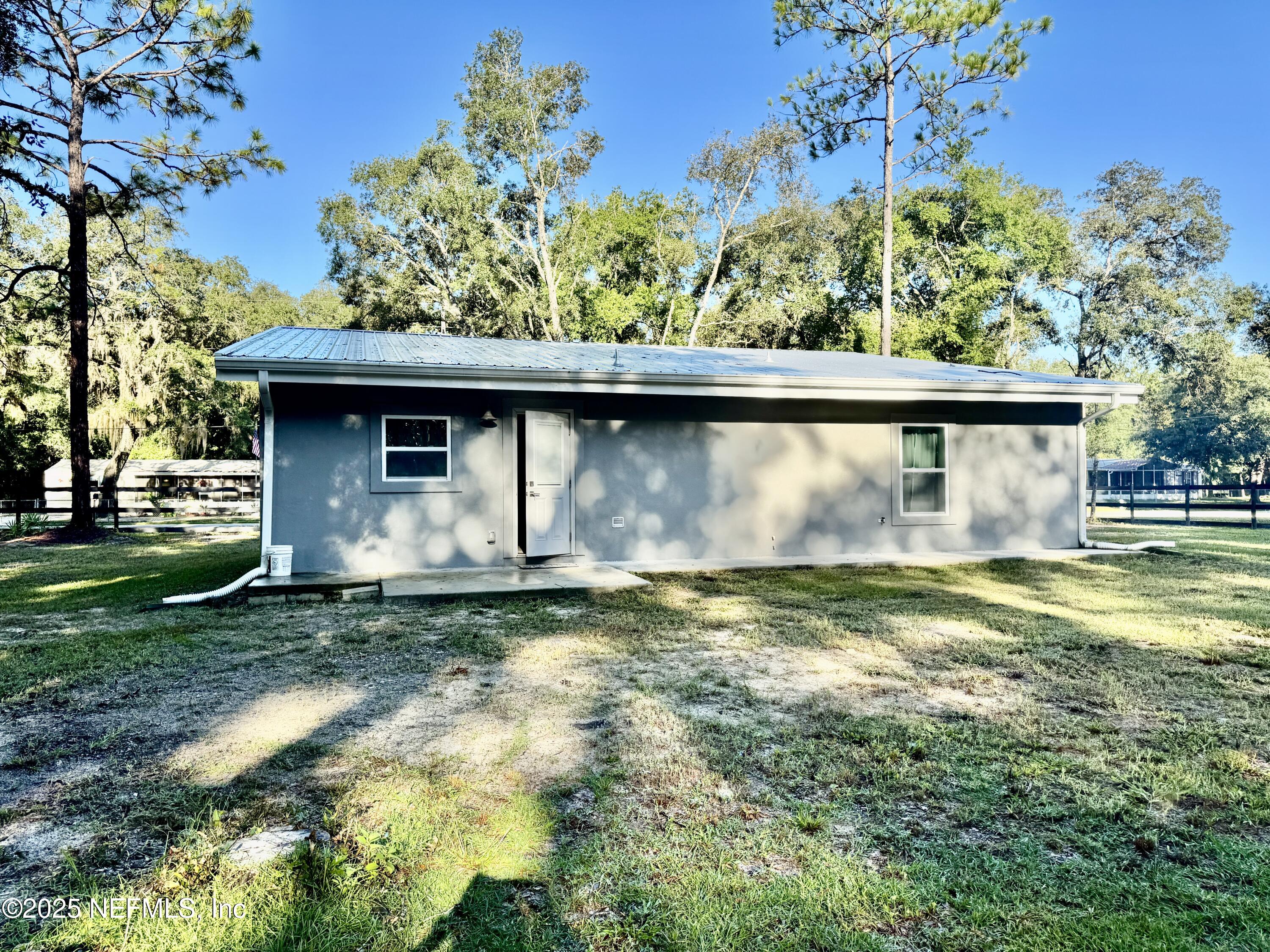 302 Azealea Avenue Interlachen, FL 32148 - Photo 14 of 38 a view of a house with a yard