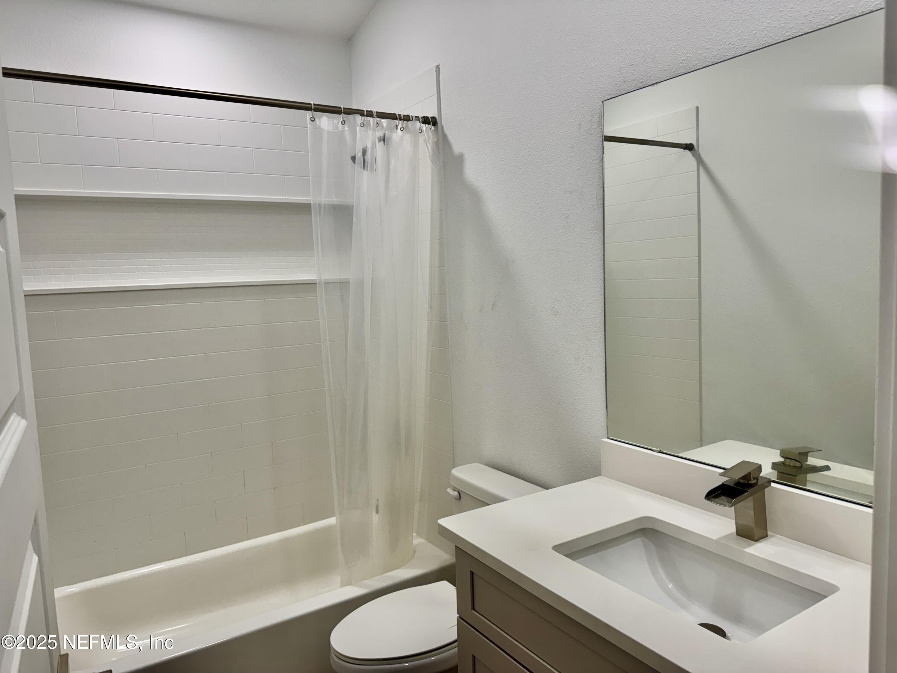 302 Azealea Avenue Interlachen, FL 32148 - Photo 22 of 38 a bathroom with a sink and a mirror