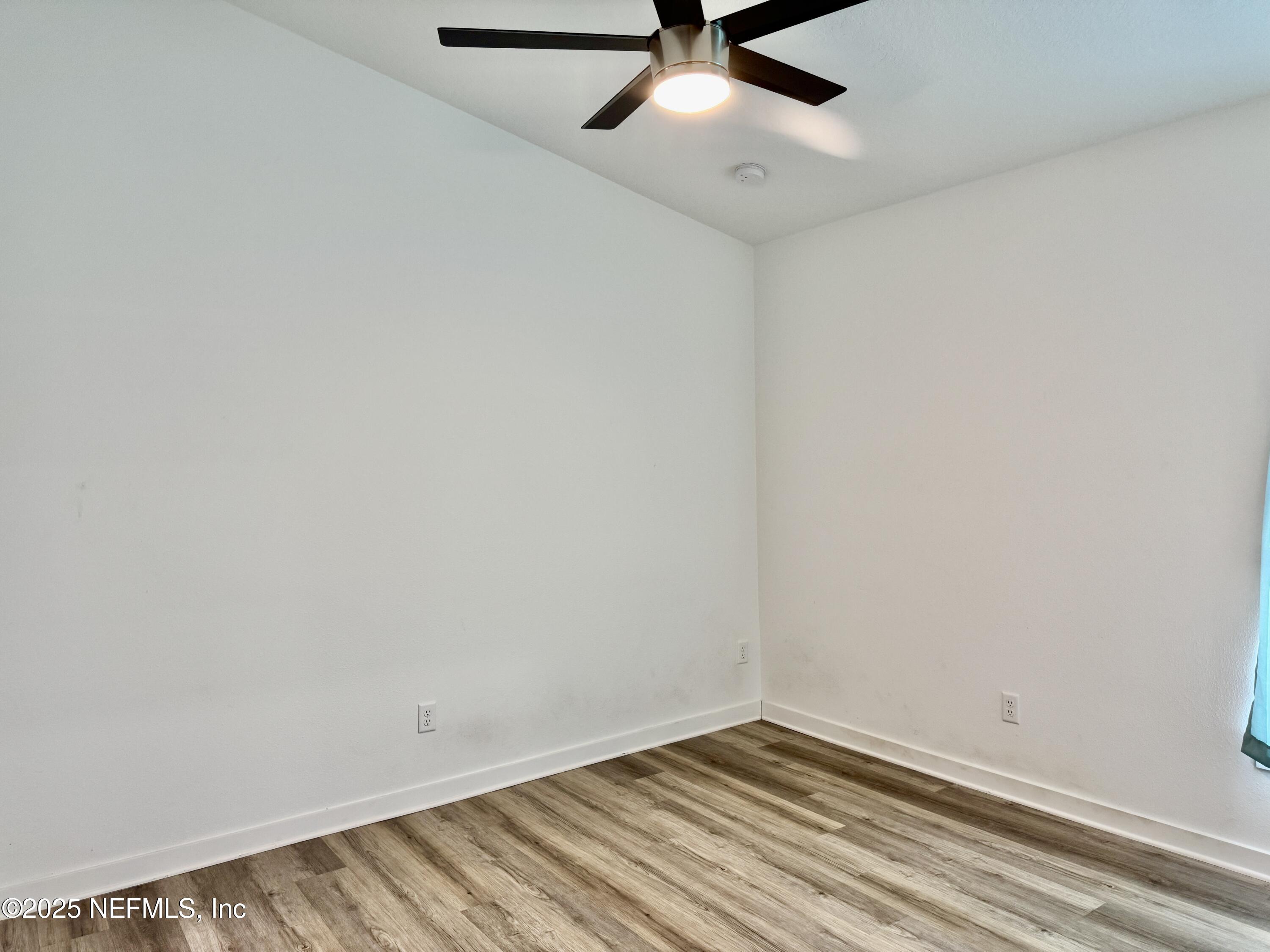 302 Azealea Avenue Interlachen, FL 32148 - Photo 26 of 38 a view of a room with wooden floor and fan