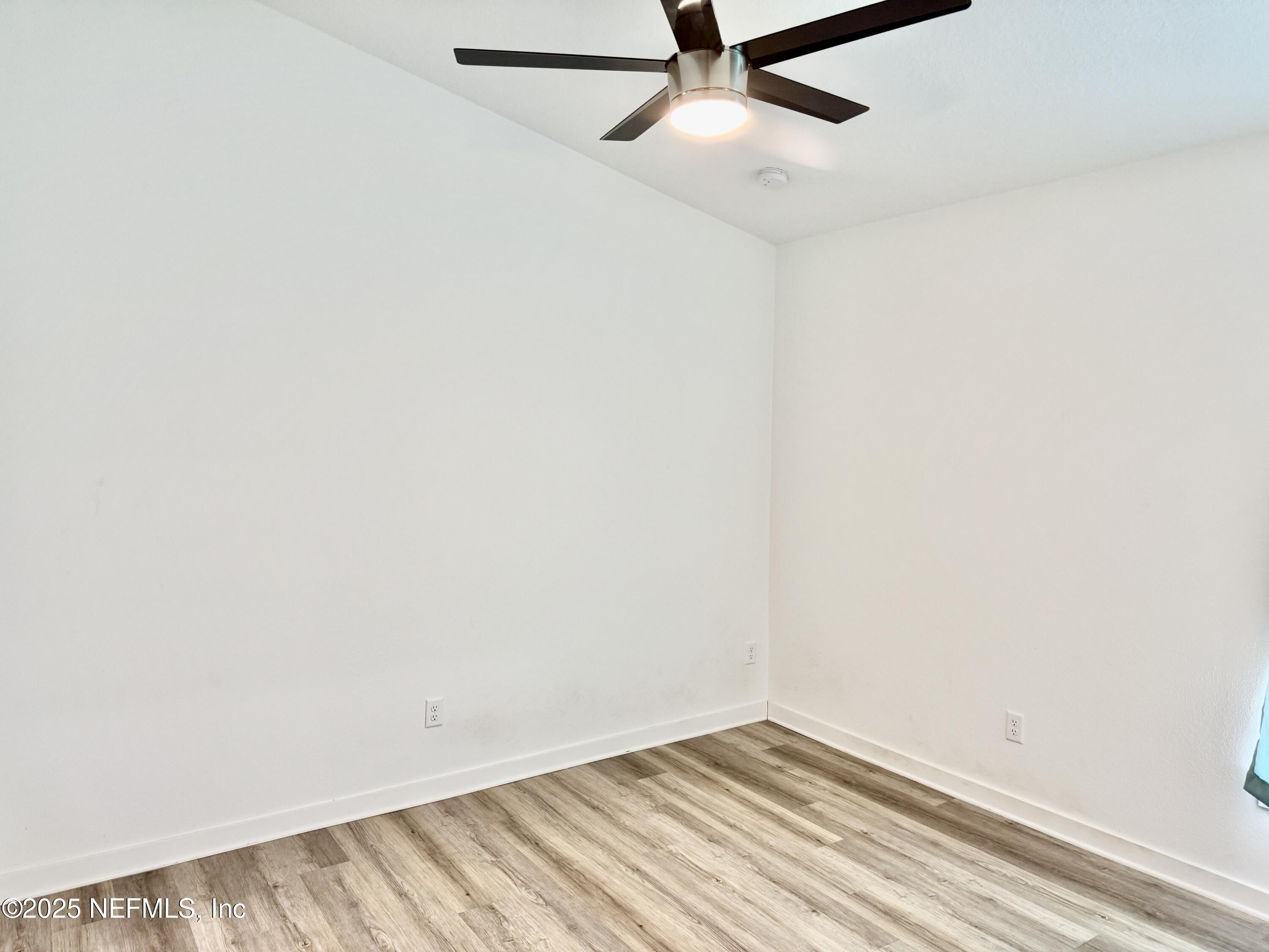 302 Azealea Avenue Interlachen, FL 32148 - Photo 30 of 38 an empty room with a ceiling fan and a window