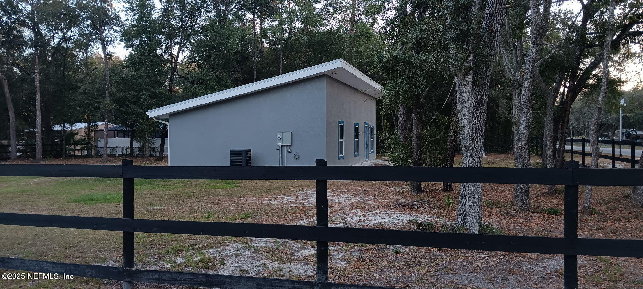 302 Azealea Avenue Interlachen, FL 32148 - Photo 5 of 38 a view of a small yard and a fence
