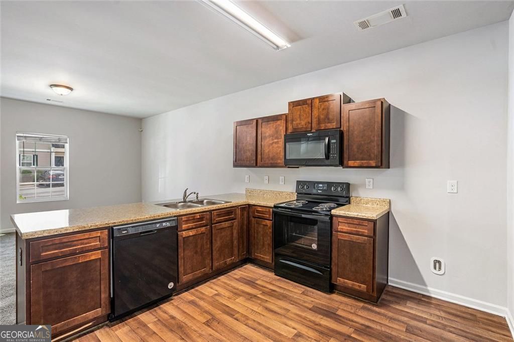 4043 Avalon Road Southwest Atlanta, GA 30331 - Photo 5 of 10 a kitchen with stainless steel appliances granite countertop a sink stove and microwave