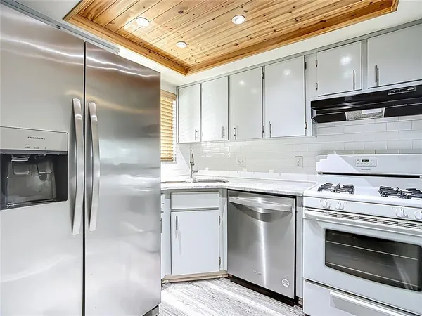 a kitchen with a stove microwave and refrigerator