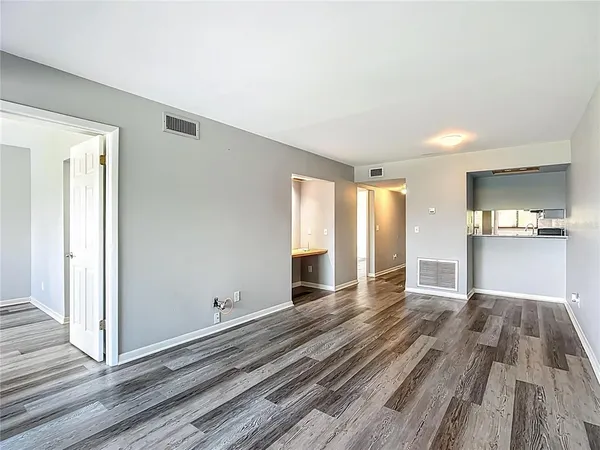a view of a room with wooden floor