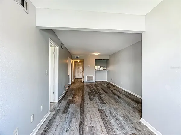 a view of a room with wooden floor
