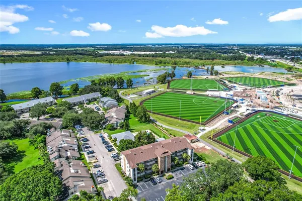 an aerial view of residential houses with outdoor space and river
