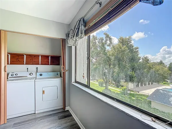 a view of washer and dryer with kitchen view