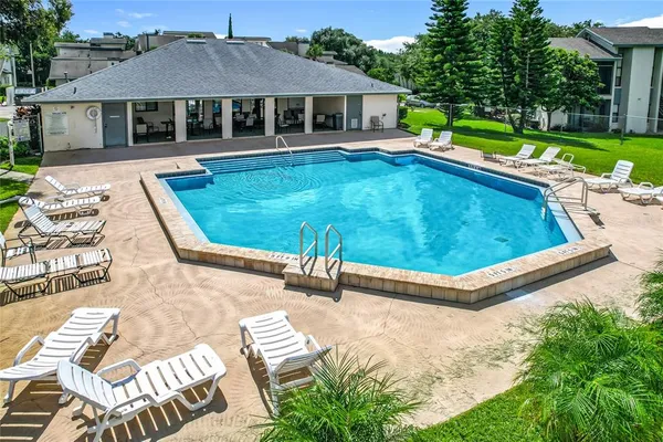 a view of a house with swimming pool and yard