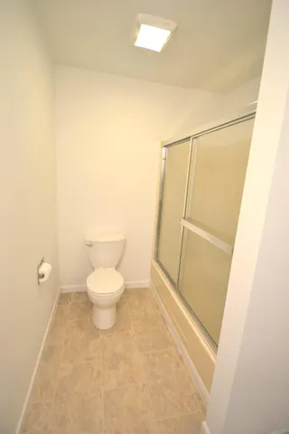 a bathroom with a toilet and a shower