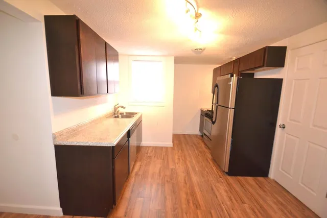 a bathroom with a sink a mirror and a shower