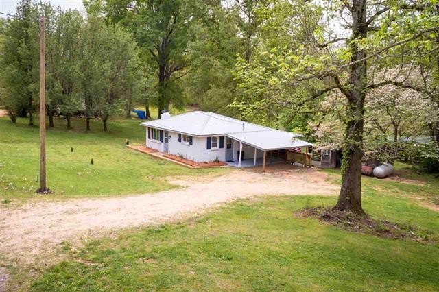 8092 Mt Carmel Road Decaturville, TN 38329 - Photo 22 of 24 a view of a house with a yard porch and sitting area