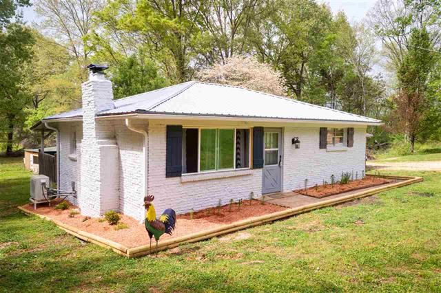 8092 Mt Carmel Road Decaturville, TN 38329 - Photo 4 of 24 a backyard of a house with yard table and chairs