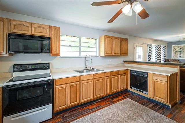 8092 Mt Carmel Road Decaturville, TN 38329 - Photo 5 of 24 a kitchen with stainless steel appliances granite countertop a stove microwave and sink