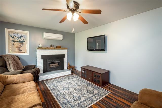 8092 Mt Carmel Road Decaturville, TN 38329 - Photo 7 of 24 a living room with furniture and a fireplace