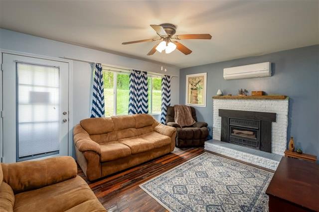 8092 Mt Carmel Road Decaturville, TN 38329 - Photo 8 of 24 a living room with furniture and a fireplace