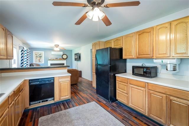8092 Mt Carmel Road Decaturville, TN 38329 - Photo 9 of 24 a kitchen with stainless steel appliances granite countertop a stove a sink dishwasher a refrigerator and a fireplace