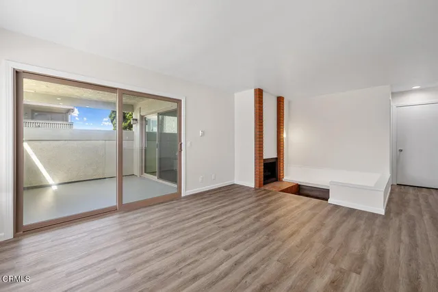 an empty room with wooden floor and closet