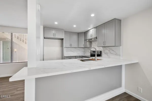 a kitchen with stainless steel appliances a sink stove and refrigerator
