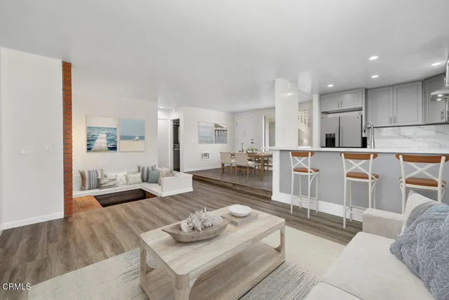 a living room with furniture kitchen view and a couch