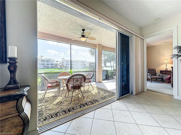 a view of a porch with furniture and floor to ceiling window