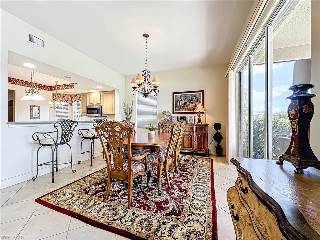 722 Regency Reserve Circle, Unit 3001 Naples, FL 34119 - Photo 19 of 50 a view of a dining room with furniture