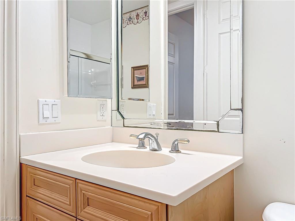 722 Regency Reserve Circle, Unit 3001 Naples, FL 34119 - Photo 25 of 50 a bathroom with a sink and a mirror