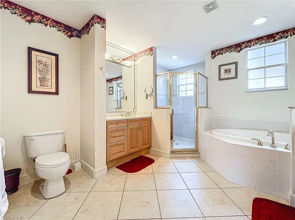 a spacious bathroom with a toilet a sink and bathtub