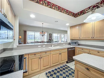 a kitchen with sink cabinets and window