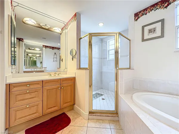 a bathroom with a tub sink and mirror
