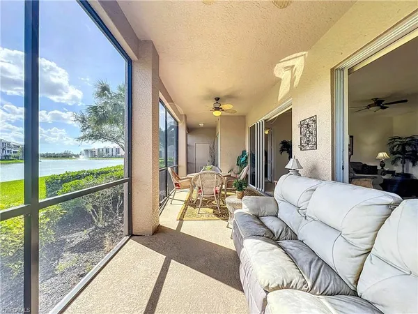 a living room with furniture and a floor to ceiling window