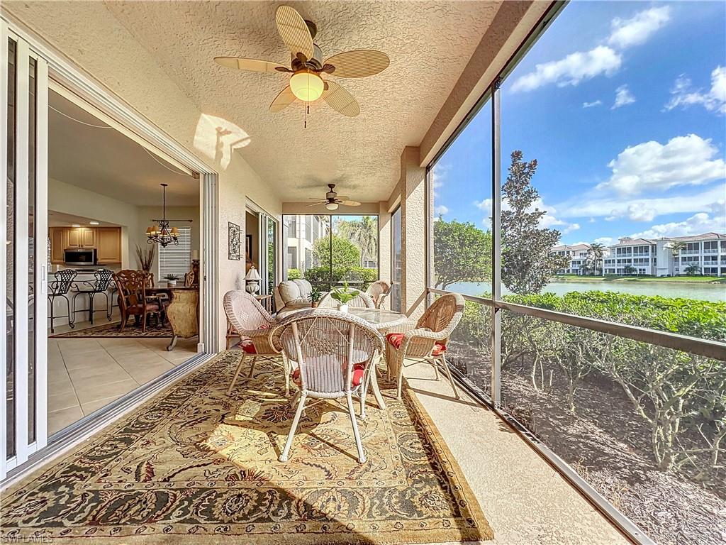 722 Regency Reserve Circle, Unit 3001 Naples, FL 34119 - Photo 37 of 50 a dining room with wooden floor a chandelier with a rug table and chairs