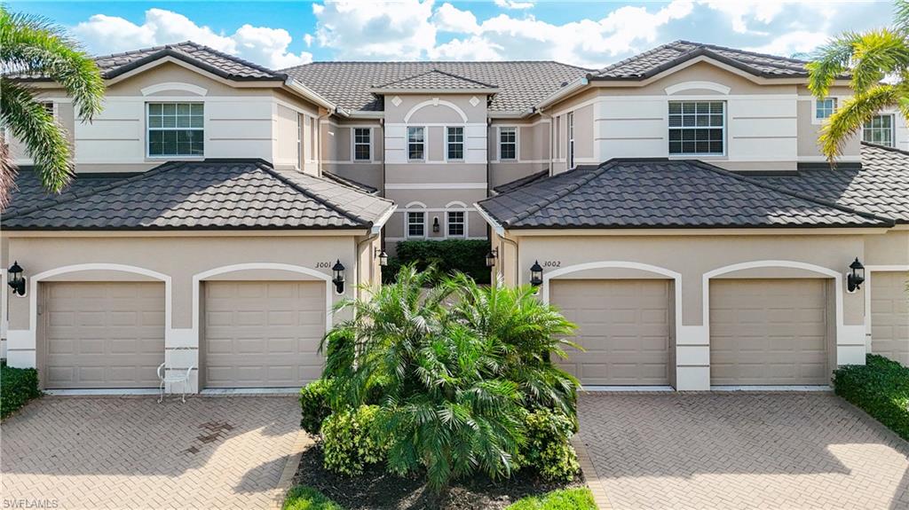 722 Regency Reserve Circle, Unit 3001 Naples, FL 34119 - Photo 48 of 50 a front view of a house with plants